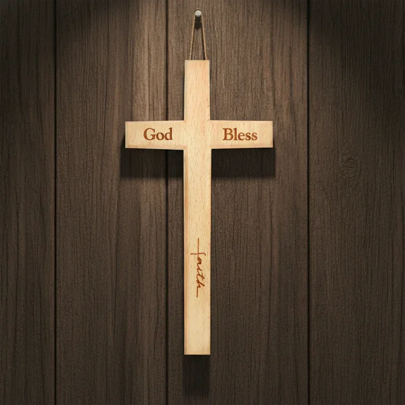 Wooden cross with 'God Bless' and 'faith' engraved on a wooden background
