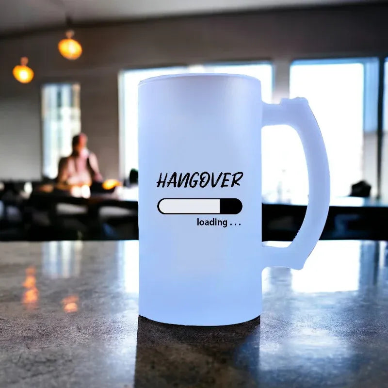 White mug with 'Hangover loading...' text on a blurred background