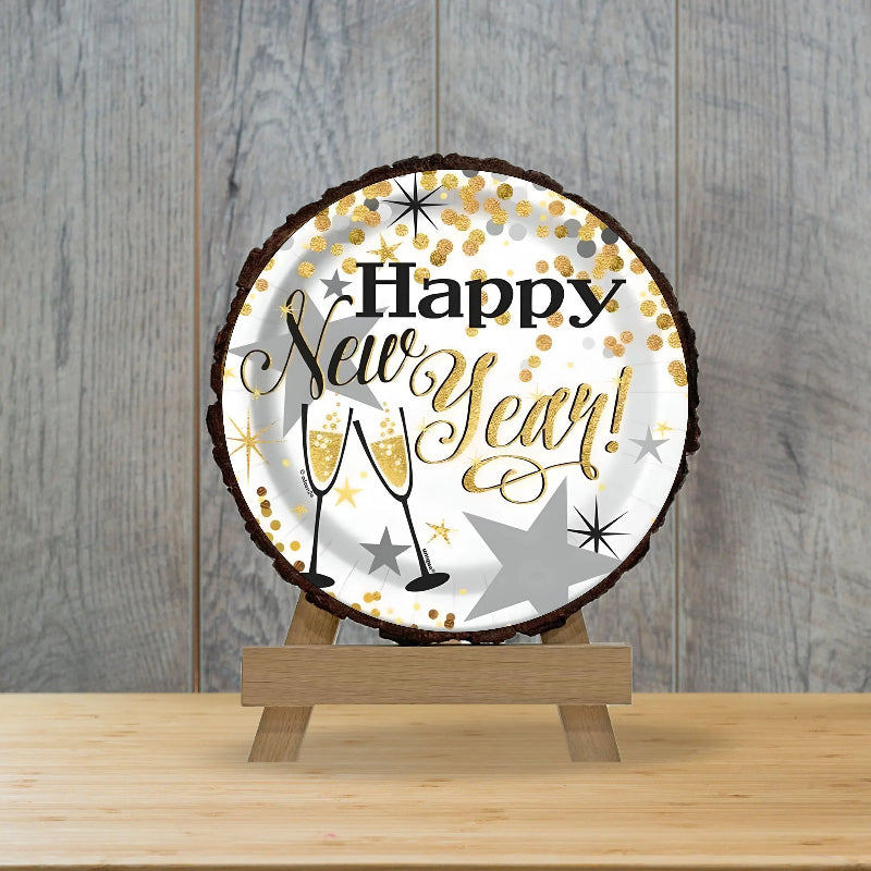Round decorative sign with 'Happy New Year!' text on a wooden stand against a wooden background