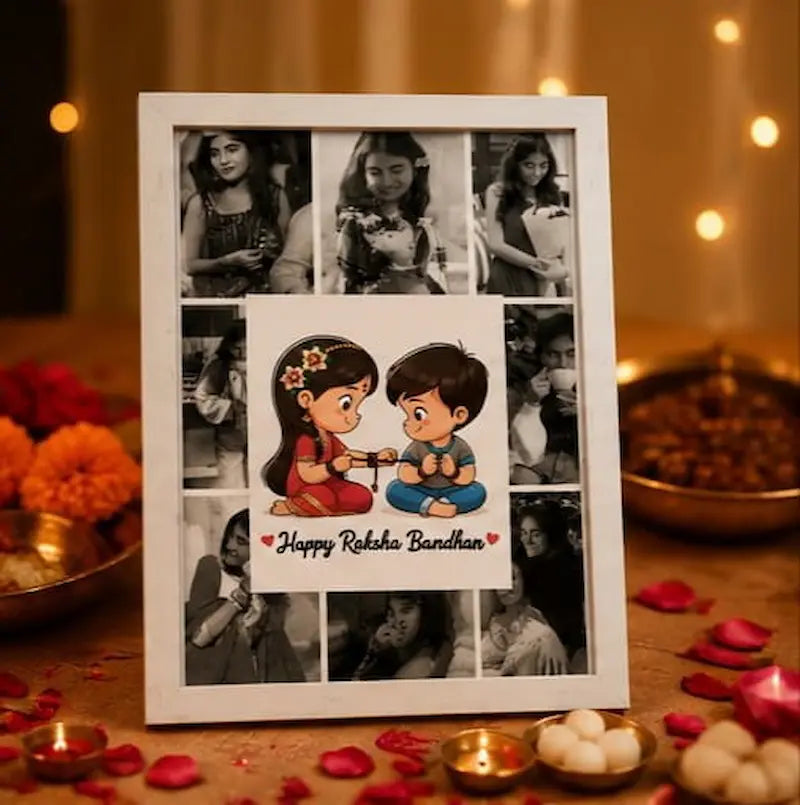 A white rectangular photo frame displayed on a decorated table, featuring a collage of black-and-white family photos around a central illustration of a girl and boy sitting together with the text 'Happy Reka Bandhan'. The scene is warmly lit with bokeh lights, marigold flowers, and traditional festive decorations.