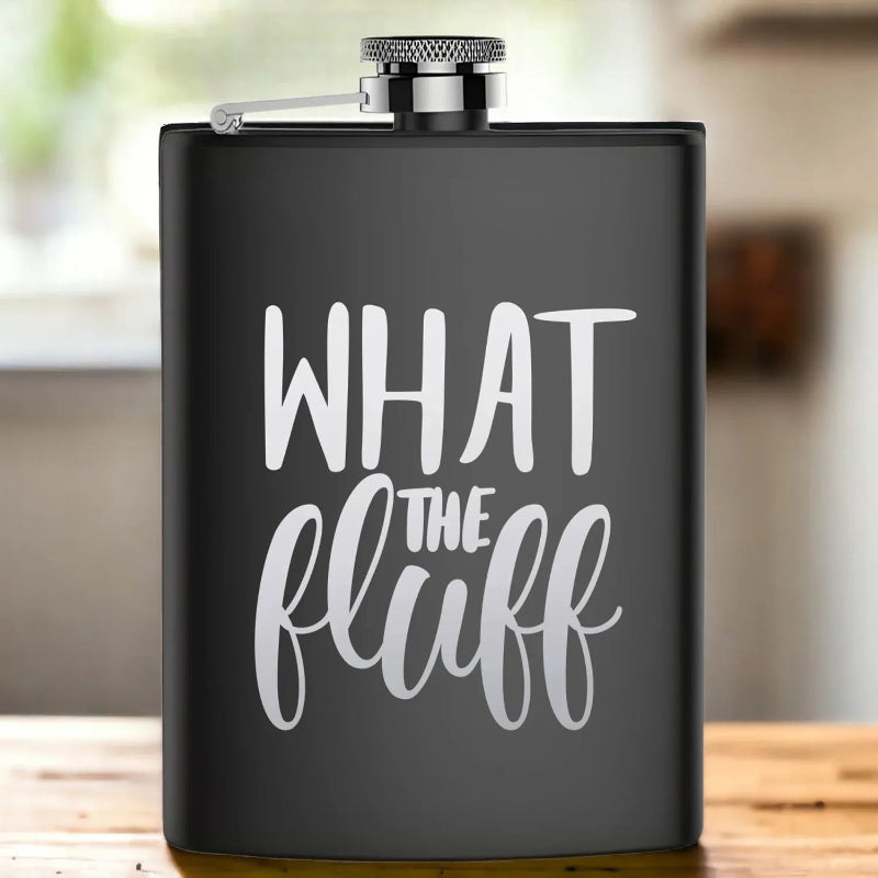 Black flask with 'WHAT THE FLUFF' text on a wooden surface