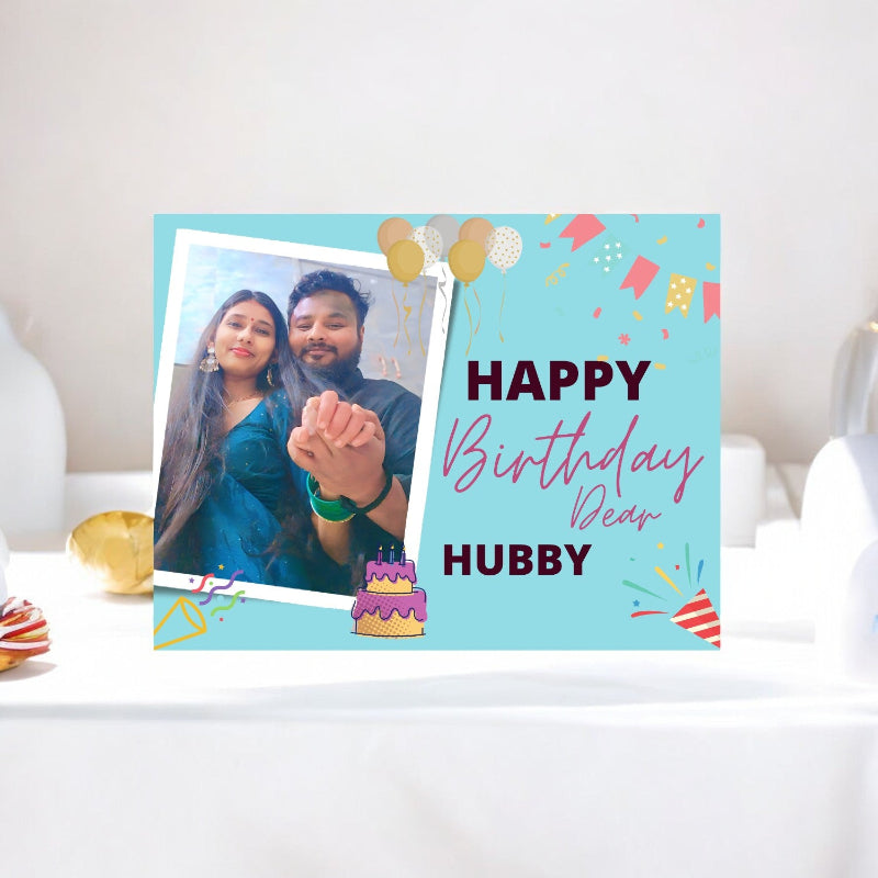 Personalized birthday card with a photo of a couple and 'Happy Birthday Dear Hubby' text on a light blue background.
