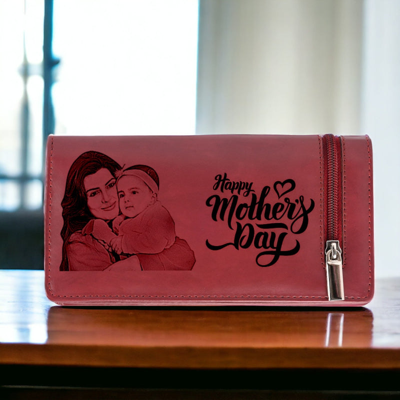 Pink wallet with a laser-cut image of a woman and child and 'Happy Mother's Day' text on a wooden surface.