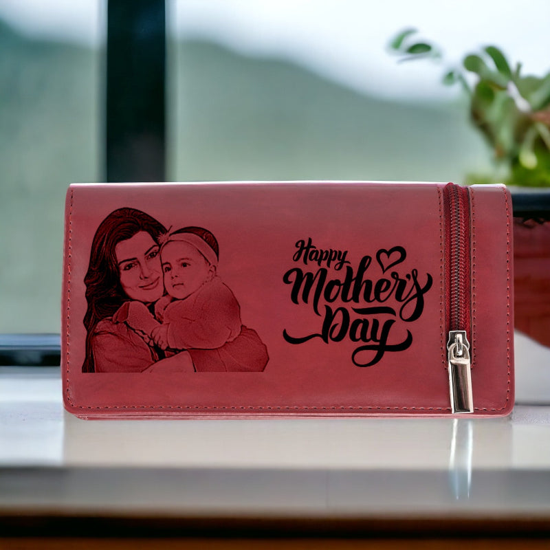 Pink wallet with a母亲's Day design featuring a woman and child, on a blurred background.