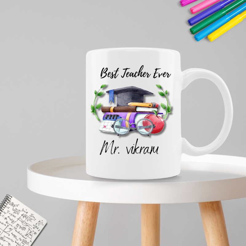 White mug with 'Best Teacher Ever' text and graphics on a gray background
