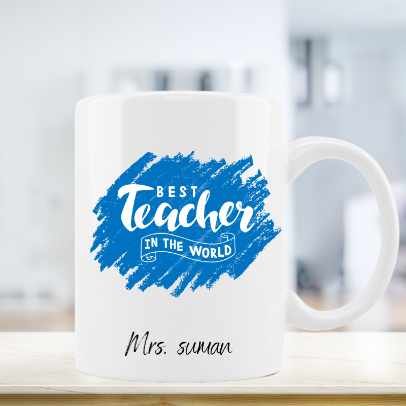 White mug with blue and black text on a blurred background