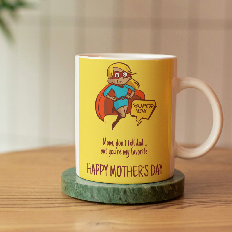 A ceramic coffee mug with a yellow background, featuring a cartoon illustration of a superhero girl with blue hair and text that reads 'Super Mom, but you're favorite!' and 'Happy Mother's Day'.