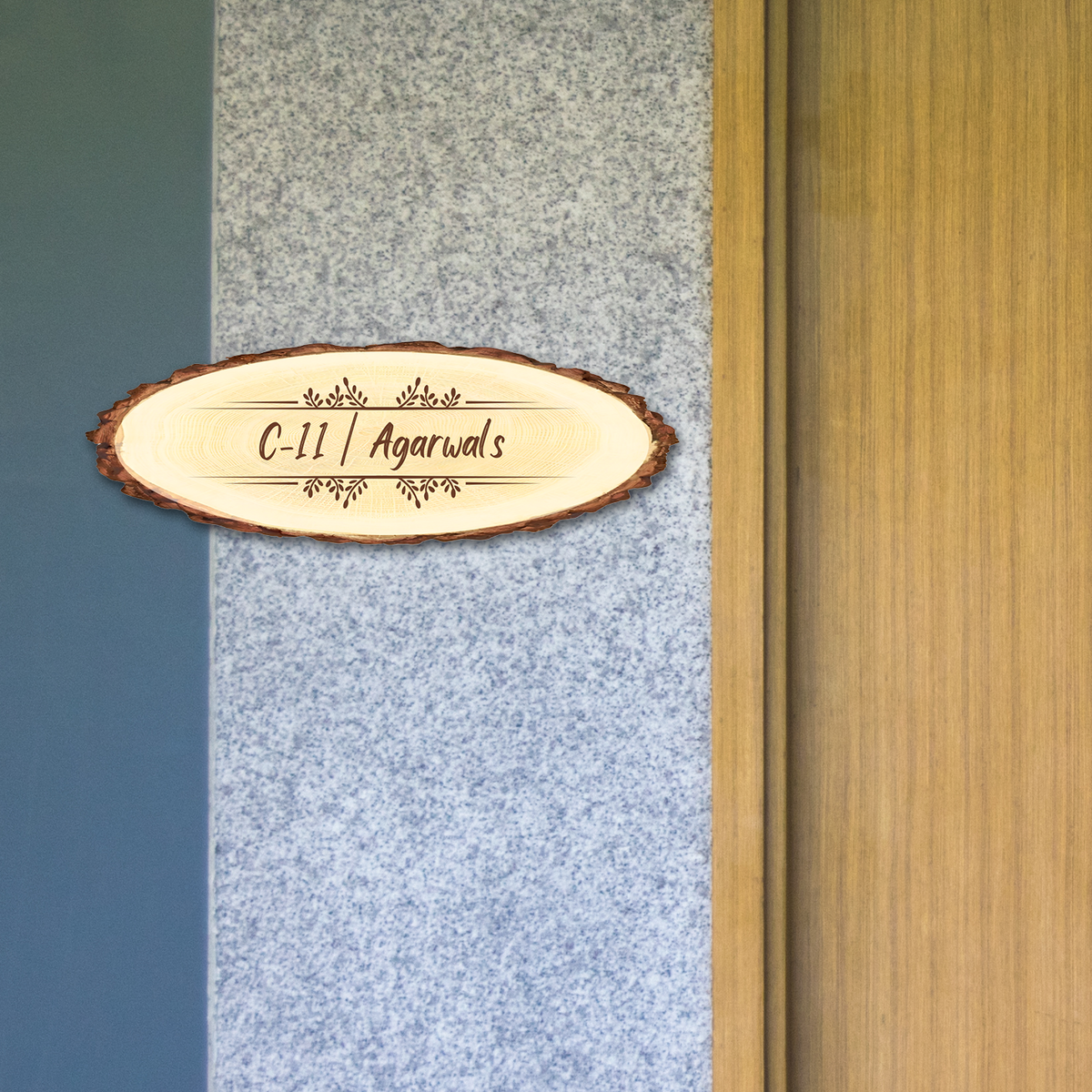 A wooden slice name plate with engraved text 'C-II / Agarwal's' hanging on a door.