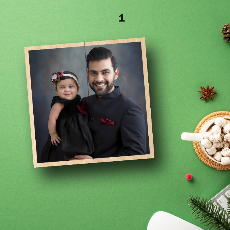 Framed photo of a man holding a child on a green background with decorative items.