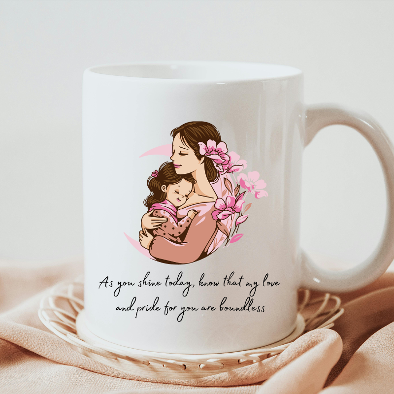White mug with a mother and child illustration and a quote on a light pink background