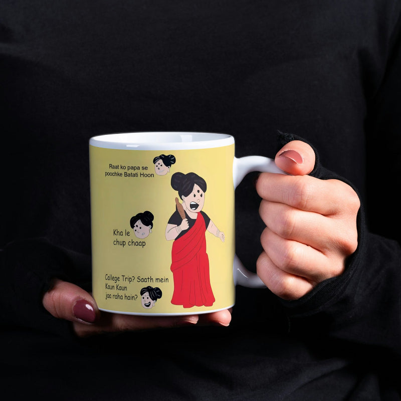 Person holding a mug with cartoon characters and text on a yellow background