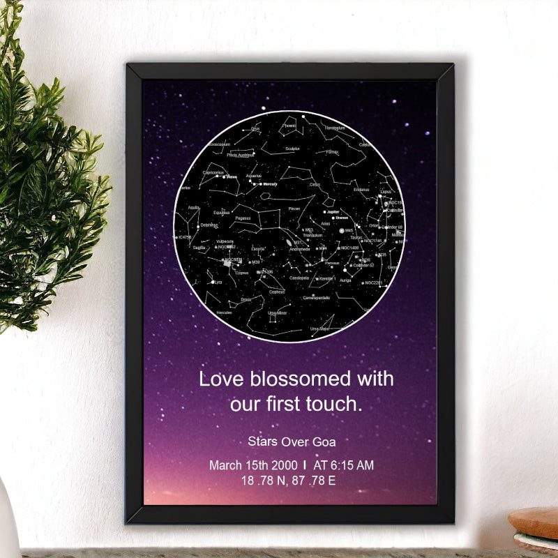 Framed star map poster with personalized text on a wall.