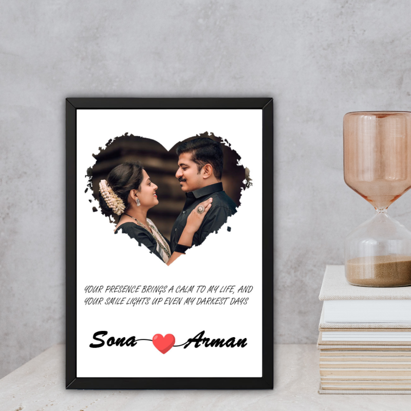 Framed artwork of a couple with personalized text on a gray surface.