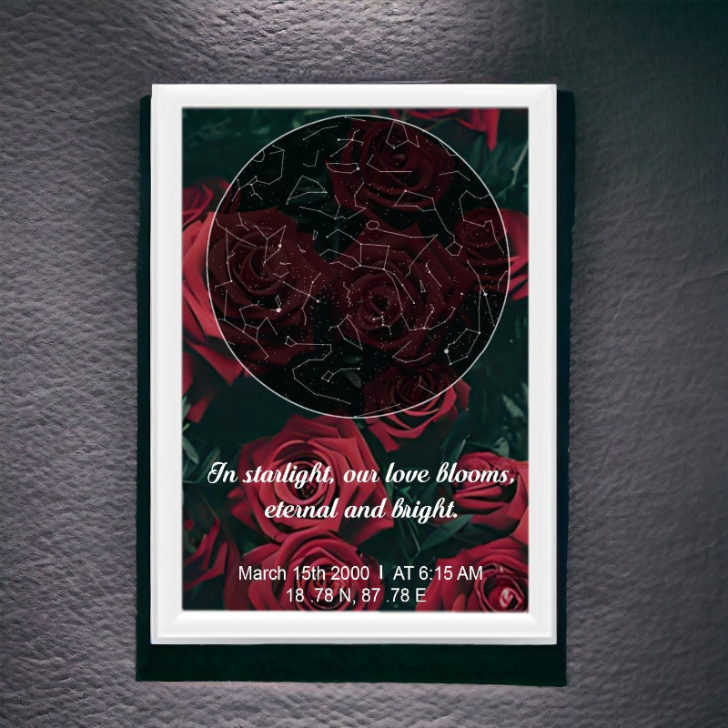A framed star map with a couple's photo and a red rose design, with text that reads 'In starlight on love blooms, Eternal and bright.' Date and time are also printed on the map.