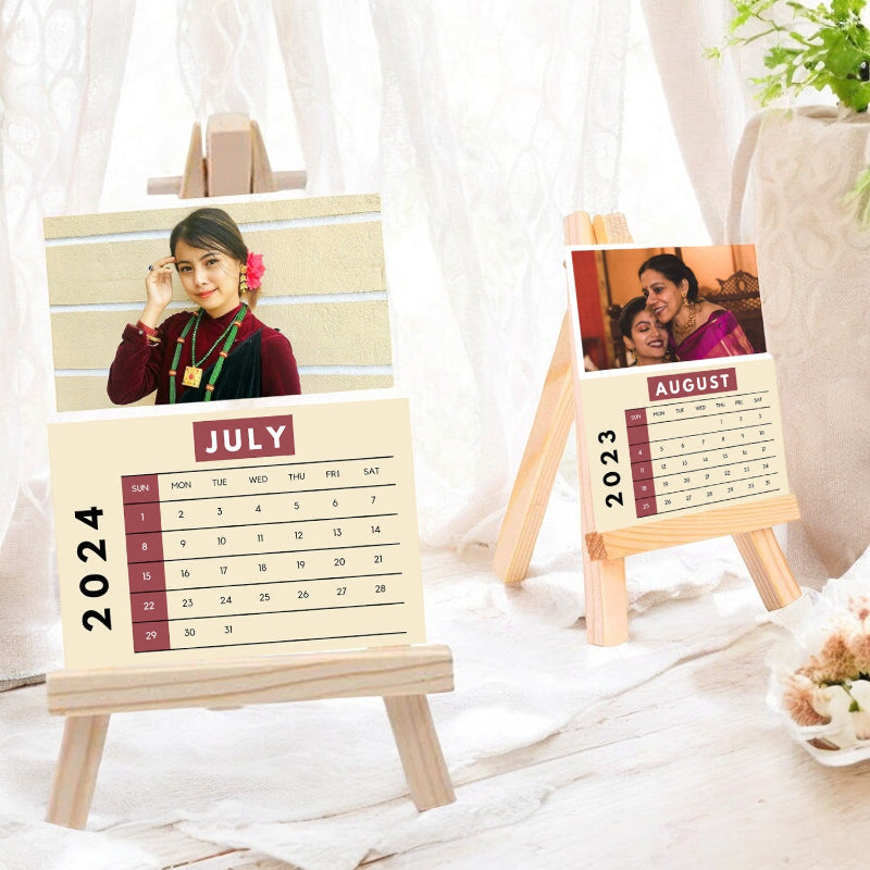 Two wooden calendars for July and August 2023 on small easels with a woman's portrait.