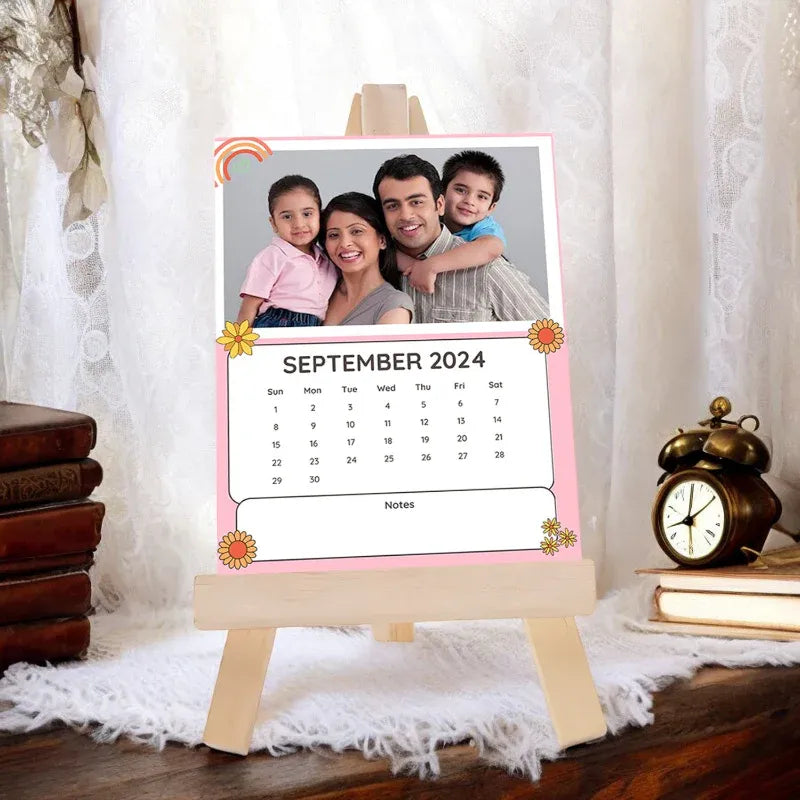 Personalized calendar with a family photo on an easel, set against a decorative background.