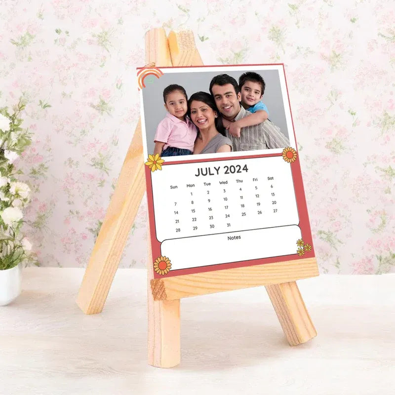 Calendar with a family photo on a wooden stand against a floral background