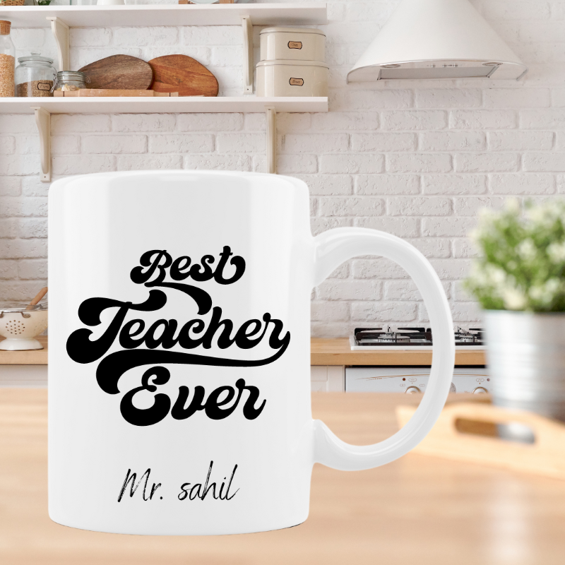 White mug with 'Best Teacher Ever' text on a kitchen counter