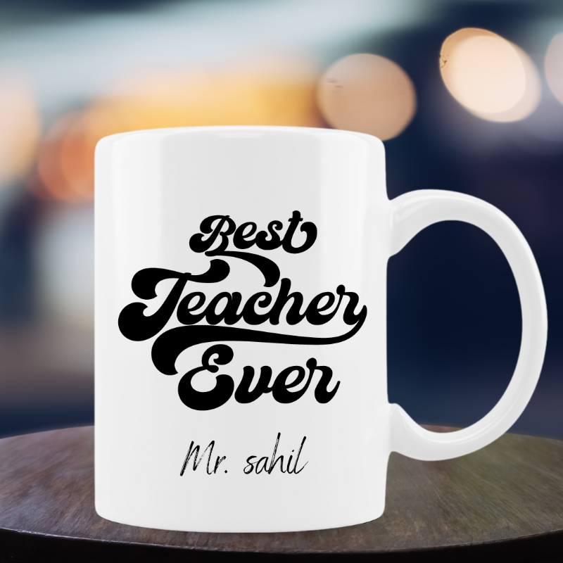 White mug with 'Best Teacher Ever' text on a blurred background