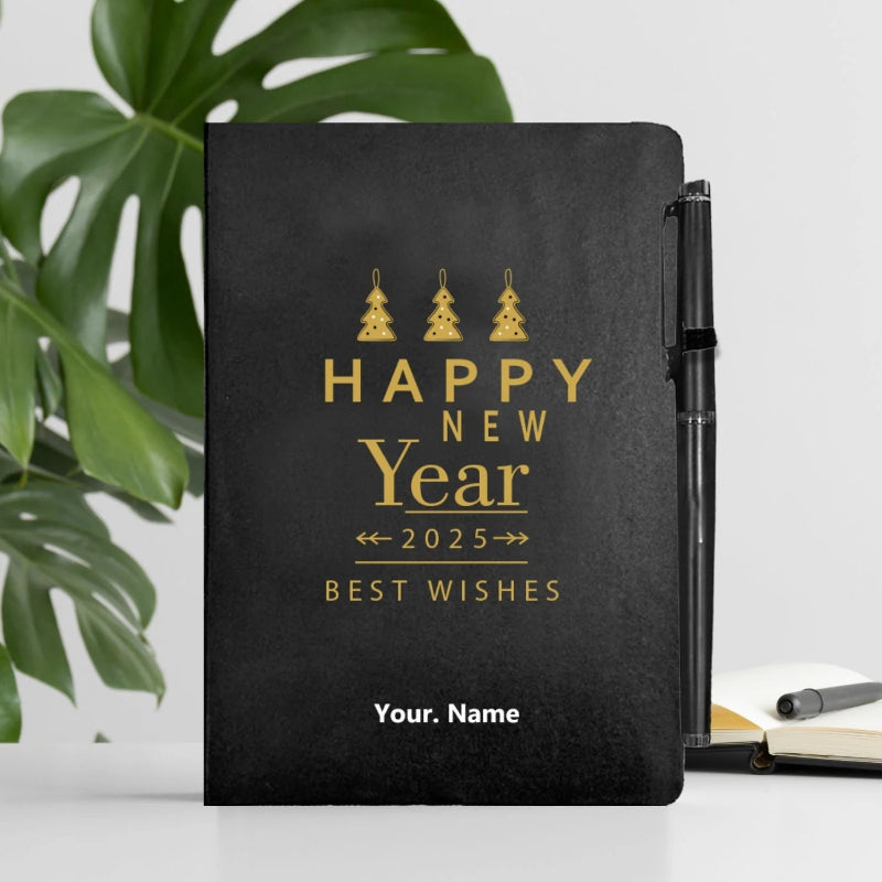 A black personalized diary with 'Happy New Year 2025 Best Wishes' printed on the cover, alongside a name placeholder. A pen is also shown resting against the diary.