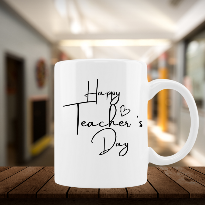 White mug with 'Happy Teacher's Day' text on a wooden surface with a blurred background