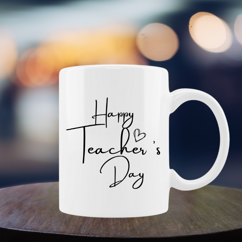 White mug with 'Happy Teacher's Day' text on a blurred background