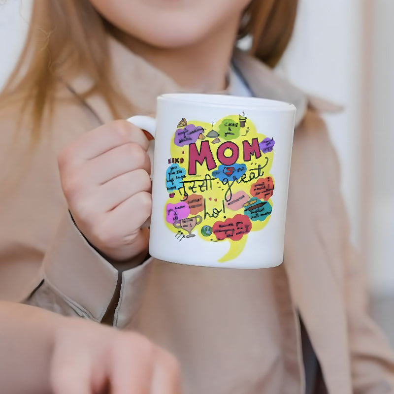 Person holding a mug with colorful text design