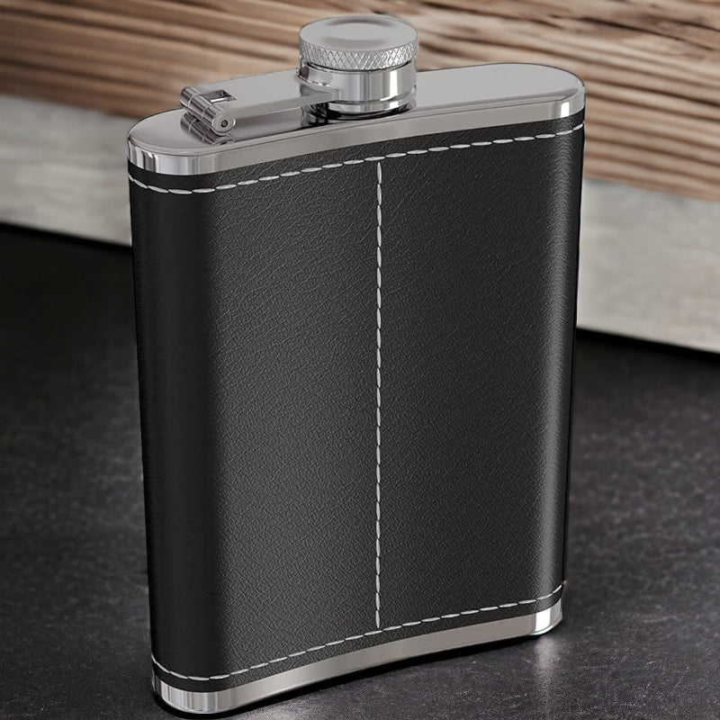 Black leather flask with silver accents on a dark surface