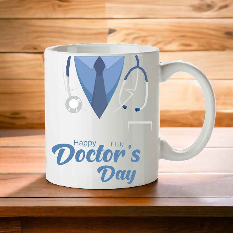 A white ceramic mug with a design featuring a blue and gray doctor's outfit, a stethoscope, and the text 'Happy Doctor's Day'.