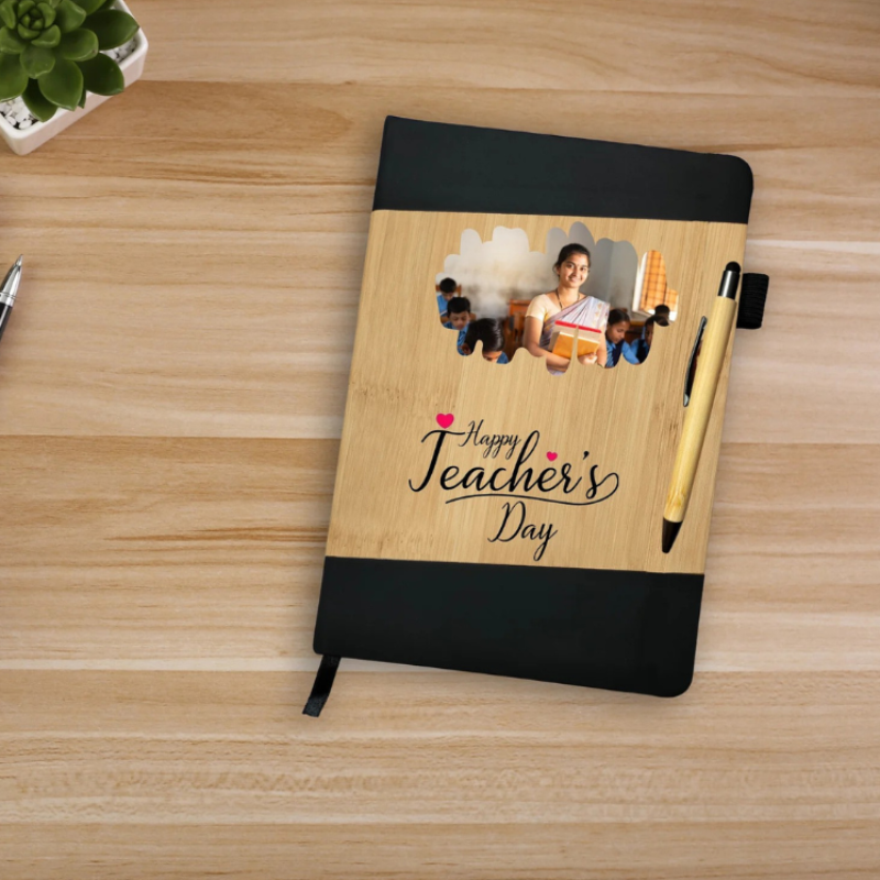 Notebook with wooden cover and black edges, featuring a photo of a teacher and students on a wooden surface.