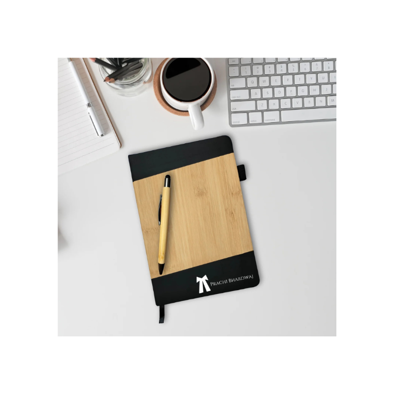Wooden notebook with pen on a desk with coffee and keyboard