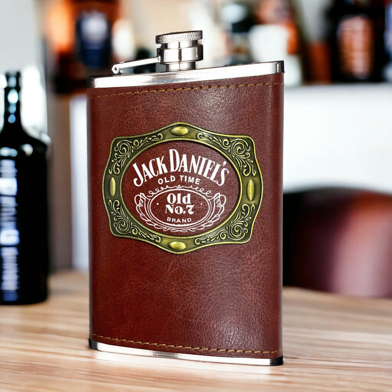 Jack Daniel's leather flask on a wooden surface with blurred background