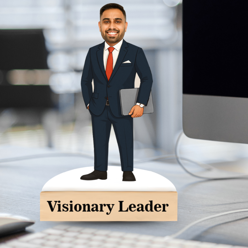 Man in a suit holding a laptop with 'Visionary Leader' text on a desk.