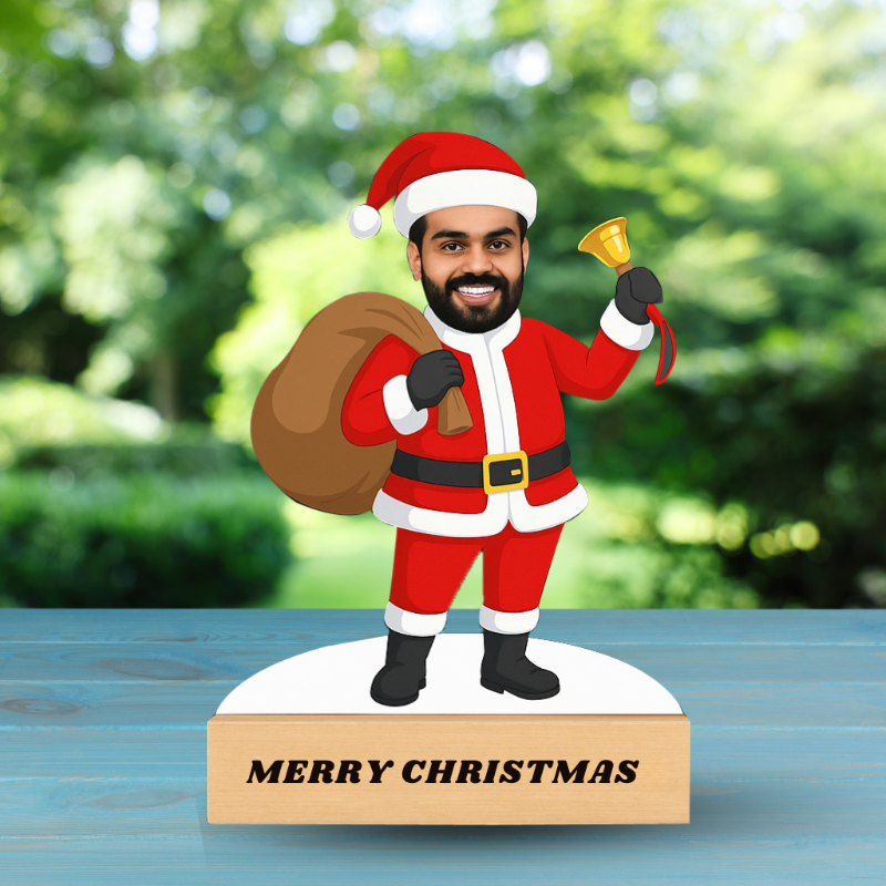 Figurine of a man in Santa Claus costume with a 'Merry Christmas' sign on a wooden base.