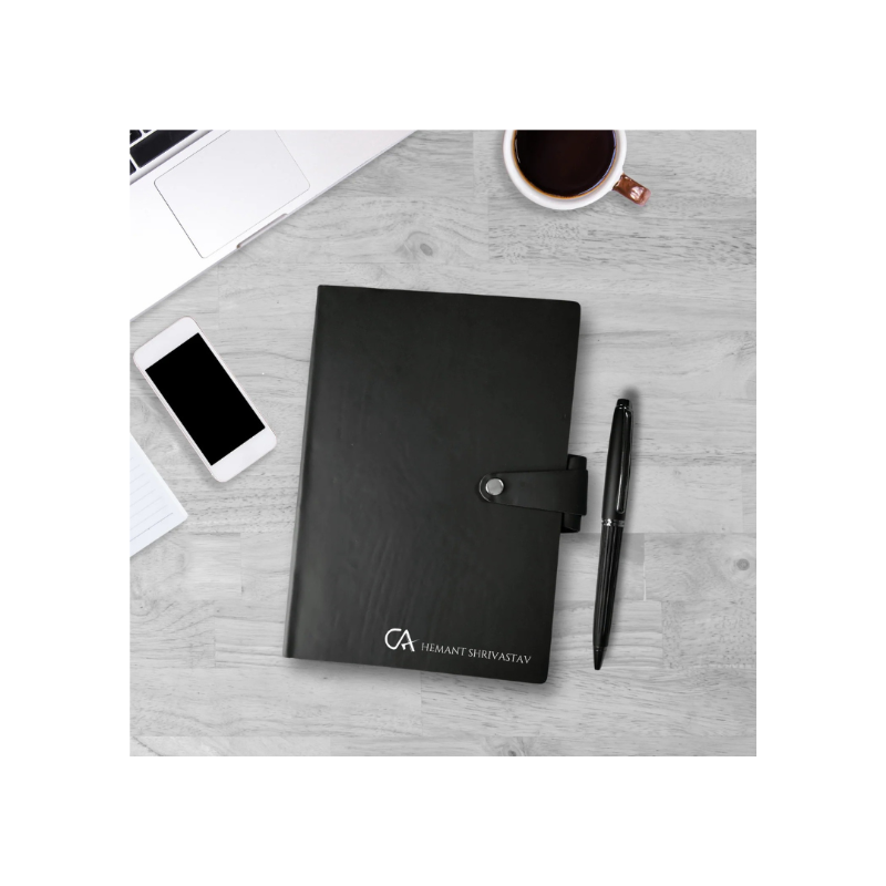 Black notebook with a pen and smartphone on a gray surface