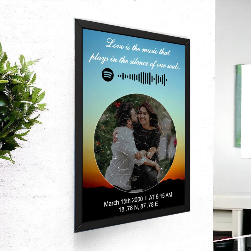 Framed artwork with a couple's photo, text, and Spotify music note on a wall.