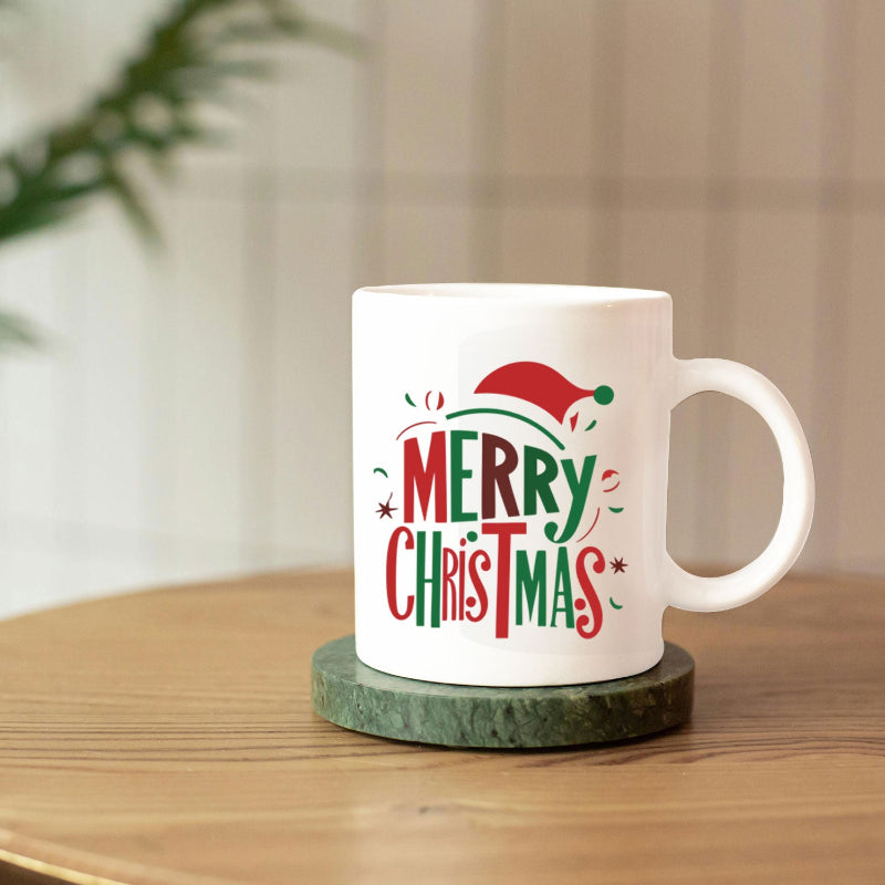 White mug with 'Merry Christmas' text on a wooden surface