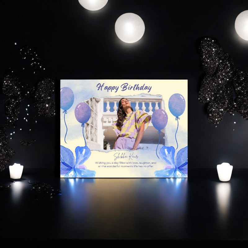 Birthday card with a person and balloons on a dark background with lights