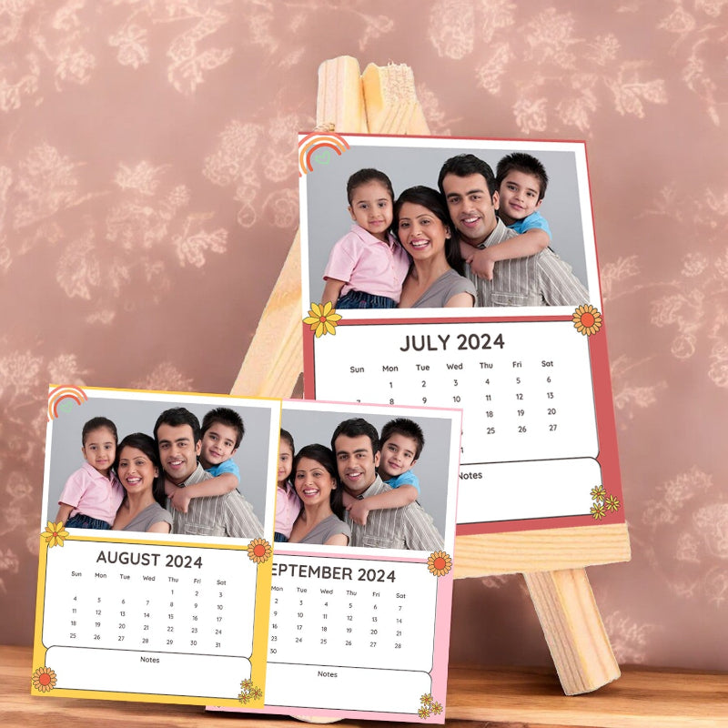 Calendar set with family photos for July, August, and September 2024 on a wooden stand.