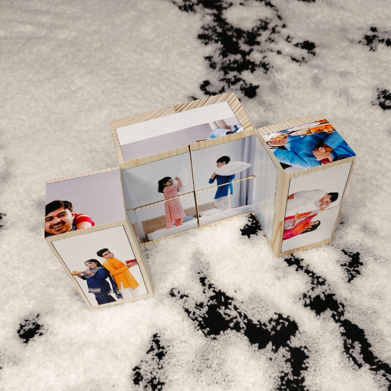 Wooden photo blocks with printed images of people on a snowy surface
