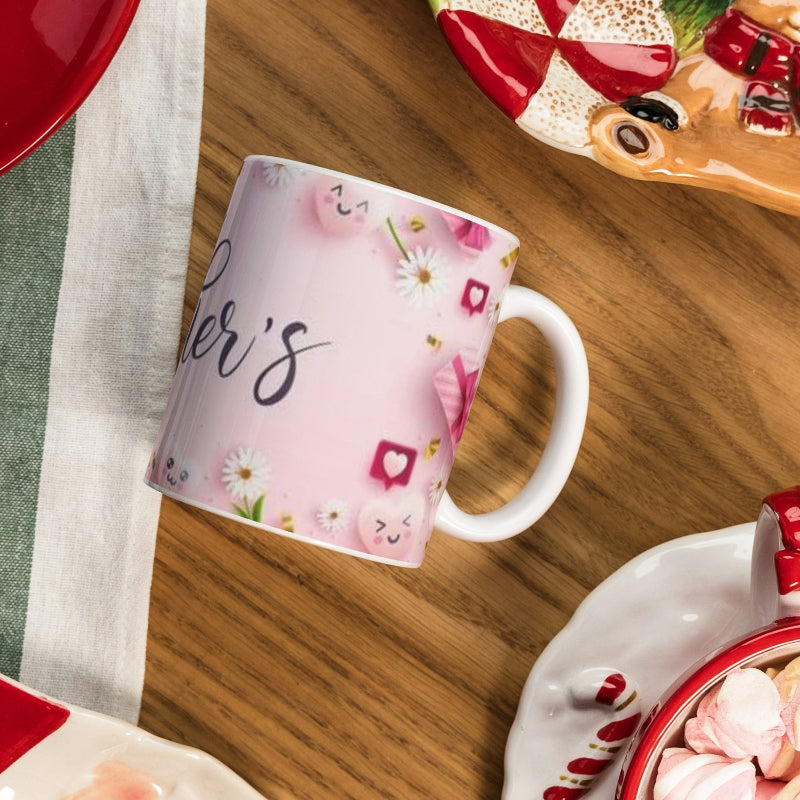 Pink mug with floral design and 'Mother's' text on a wooden table.