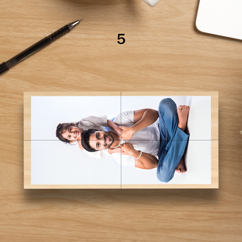 Wooden photo frame with a cut-out picture of a couple on a wooden surface.