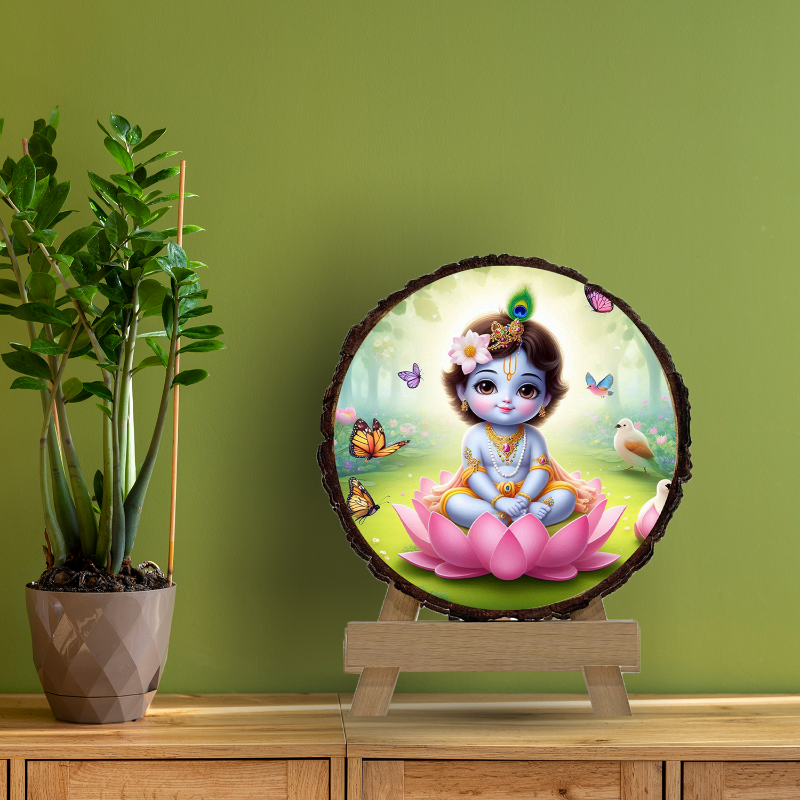 A circular wooden picture frame featuring an illustration of baby Krishna with a serene expression, surrounded by a natural wood texture, with decorative elements like butterflies and flowers in the background.