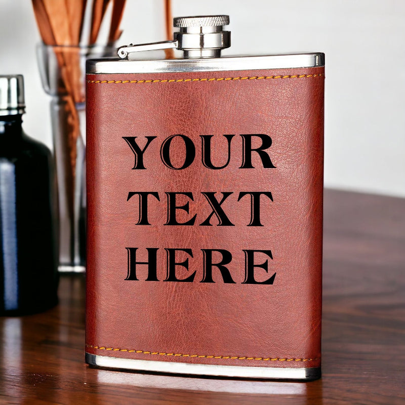 Brown leather flask with 'YOUR TEXT HERE' text on a wooden surface
