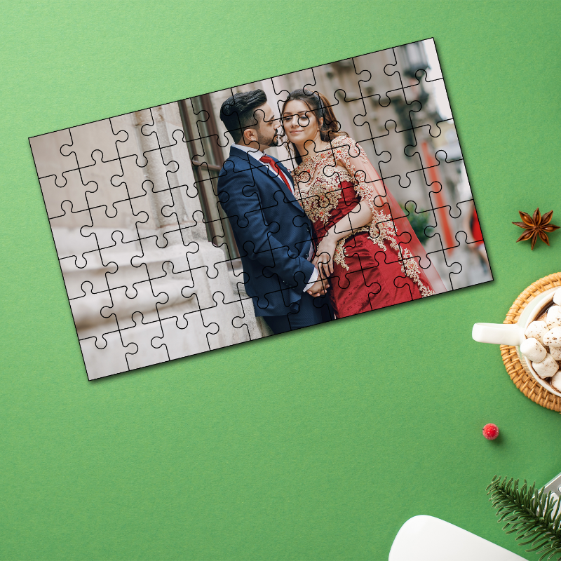 Personalized photo puzzle of a couple on a green surface with festive decorations.