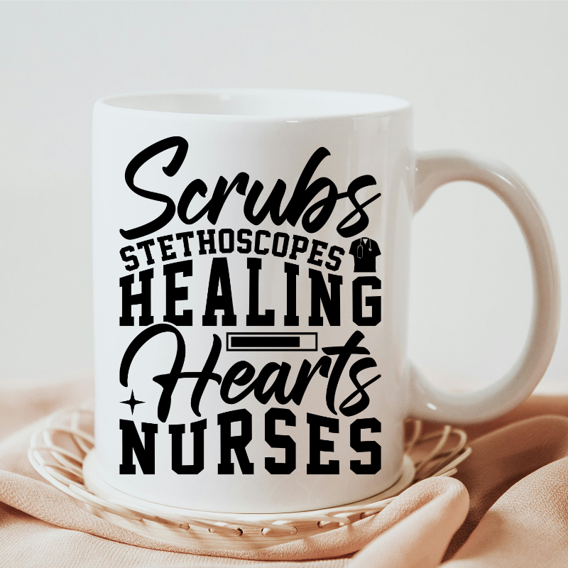 White mug with black text 'Scrubs Stethoscopes Healing Hearts Nurses' on a beige surface.