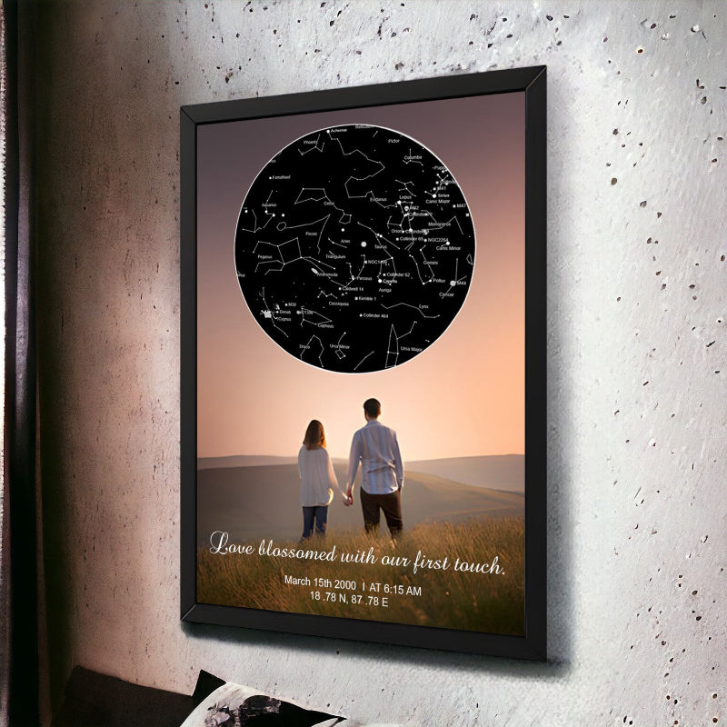 Framed artwork of a couple holding hands with a star map and text on a textured wall.