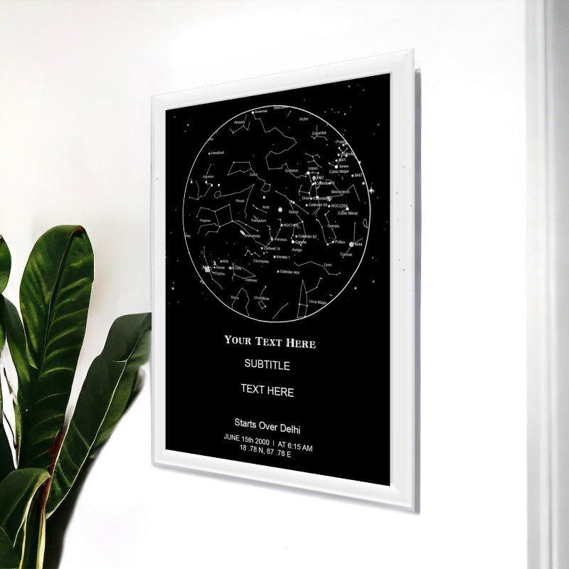 Framed star map poster with customizable text on a white wall.