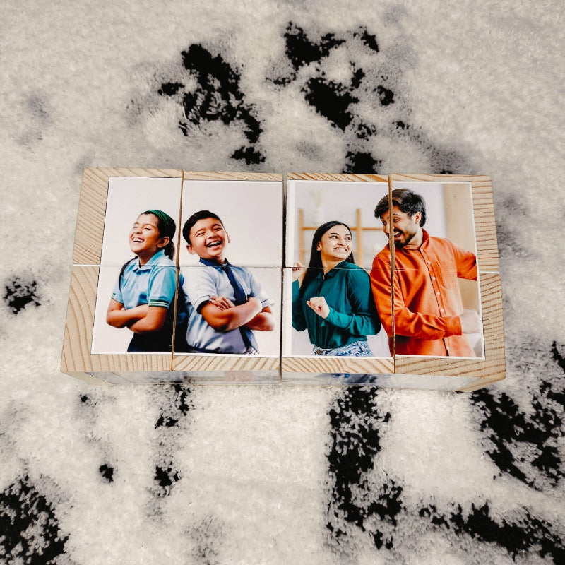 Wooden photo album with four photo panels on a textured surface
