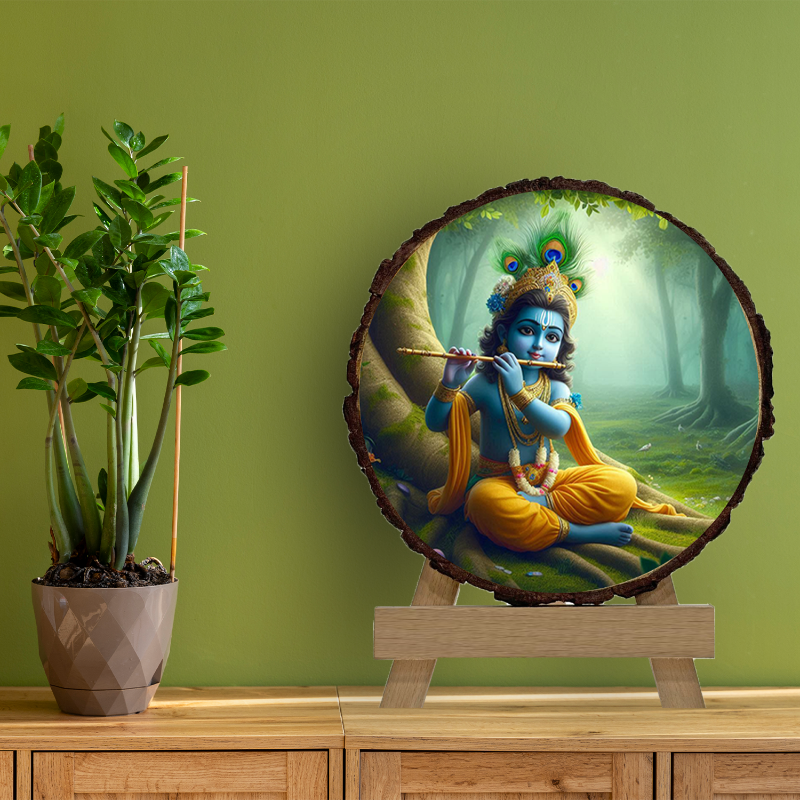 A framed picture of Lord Krishna playing the flute, set against a forest background, displayed on a wooden slice with a greenish tint, placed on a wooden easel.